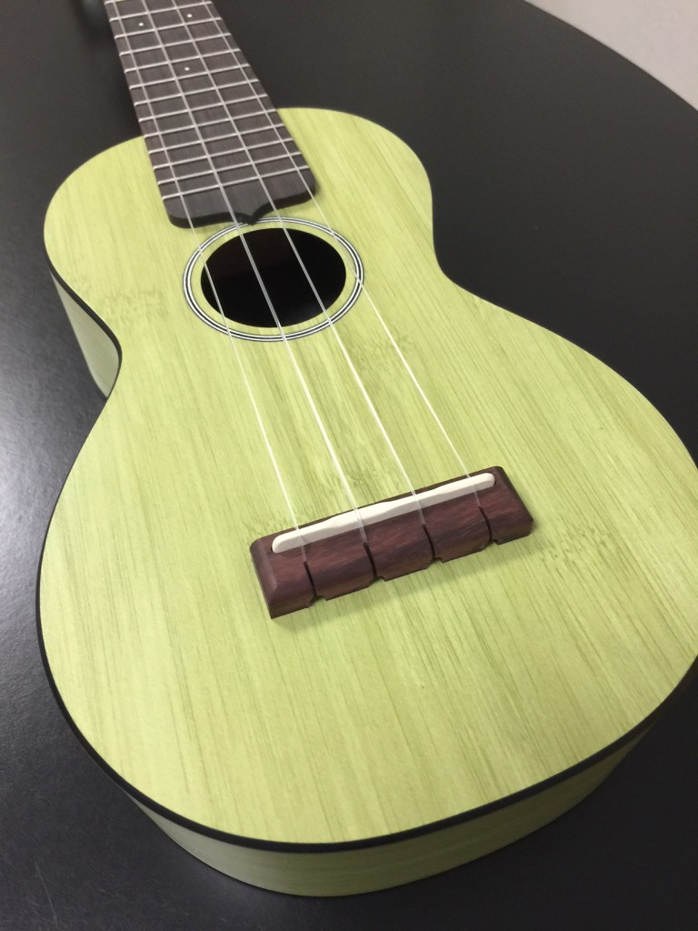 The body is made from Martin's HPL, a composite material, with Sitka spruce bracing and a bamboo-patterned finish on the top, back, sides, and headstock face.